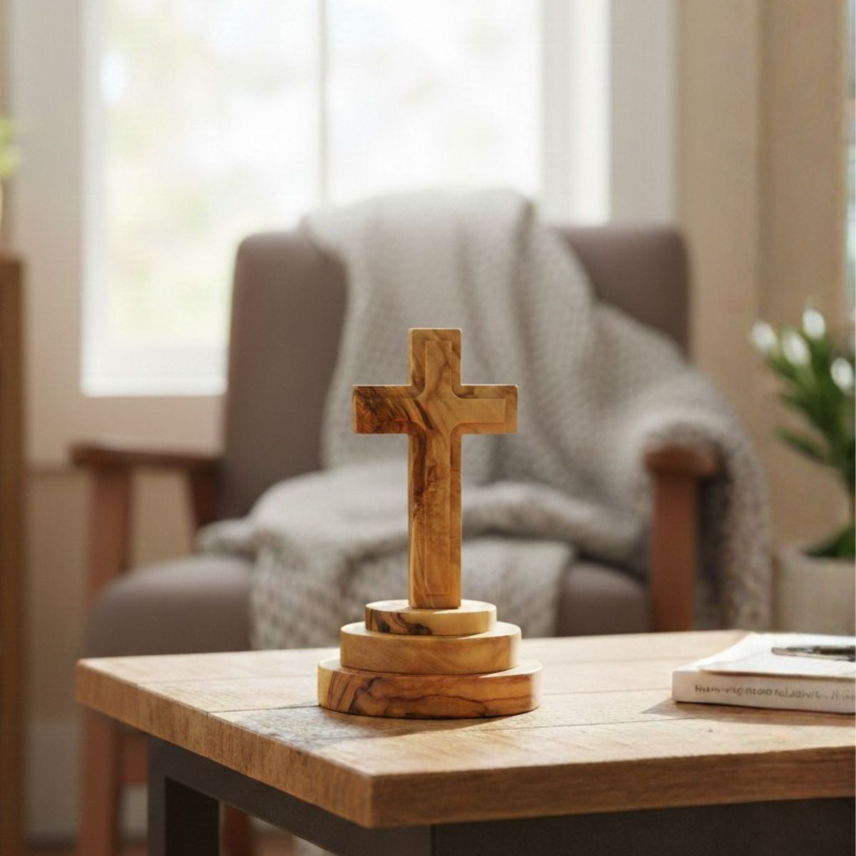 Wooden cross on a table in a cozy living room