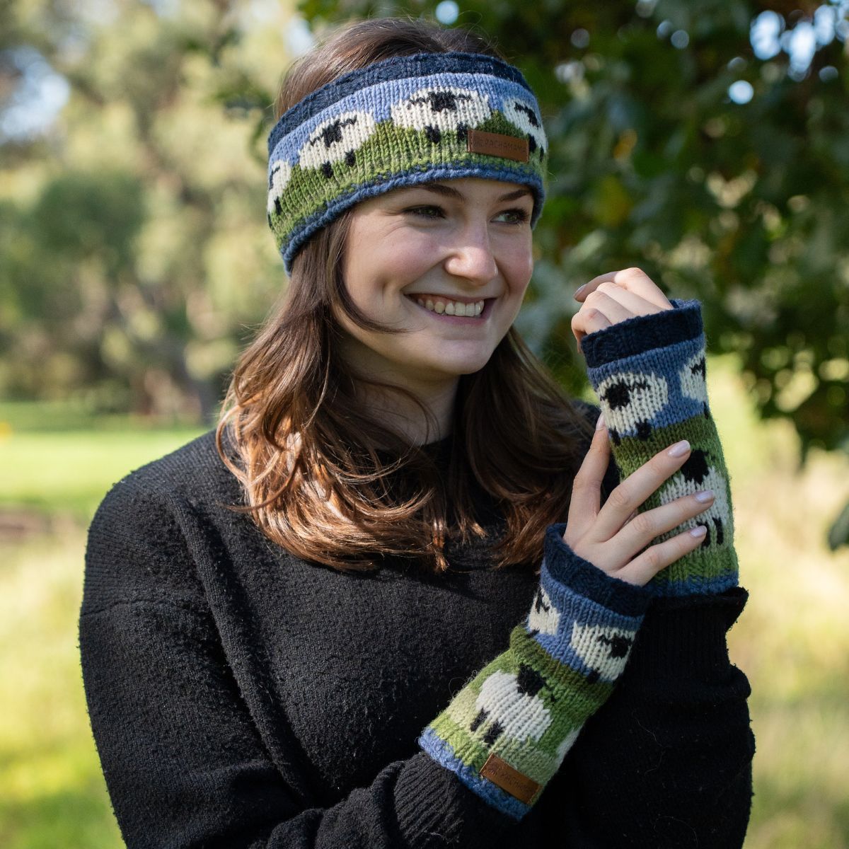 Woman wearing a knitted headband and gloves with sheep pattern outdoors