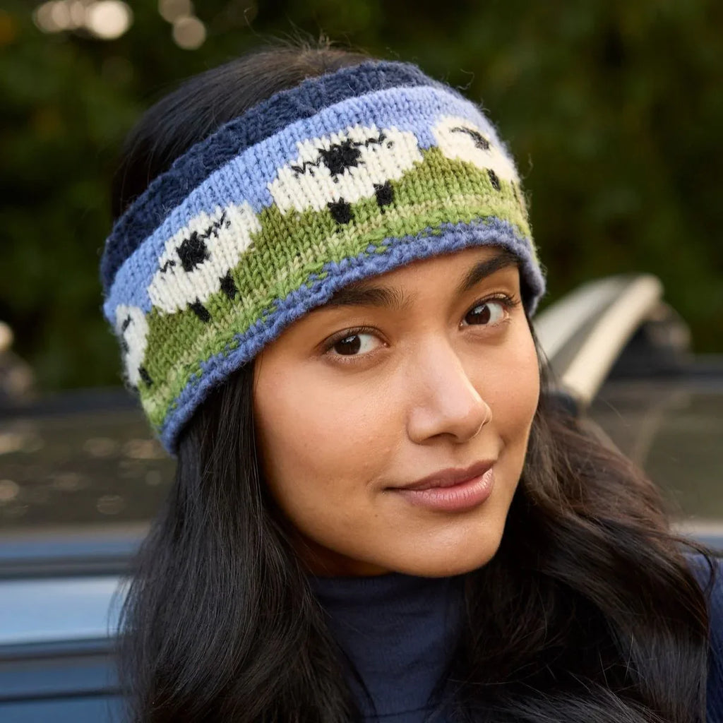 Woman wearing a knitted headband with sheep pattern outdoors