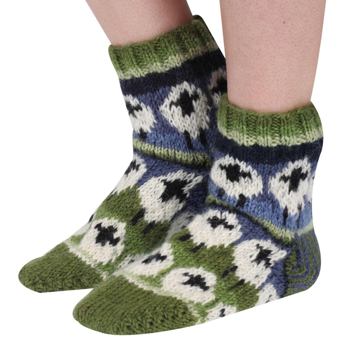 Knitted socks with a pattern of white shapes on a blue background, worn by a person on a white background.