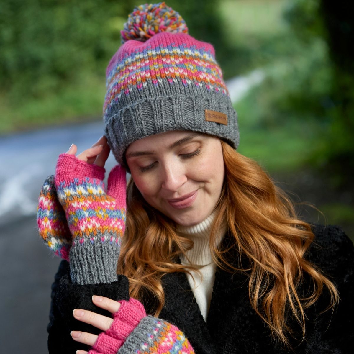 Woman wearing a colorful knit hat and gloves outdoors