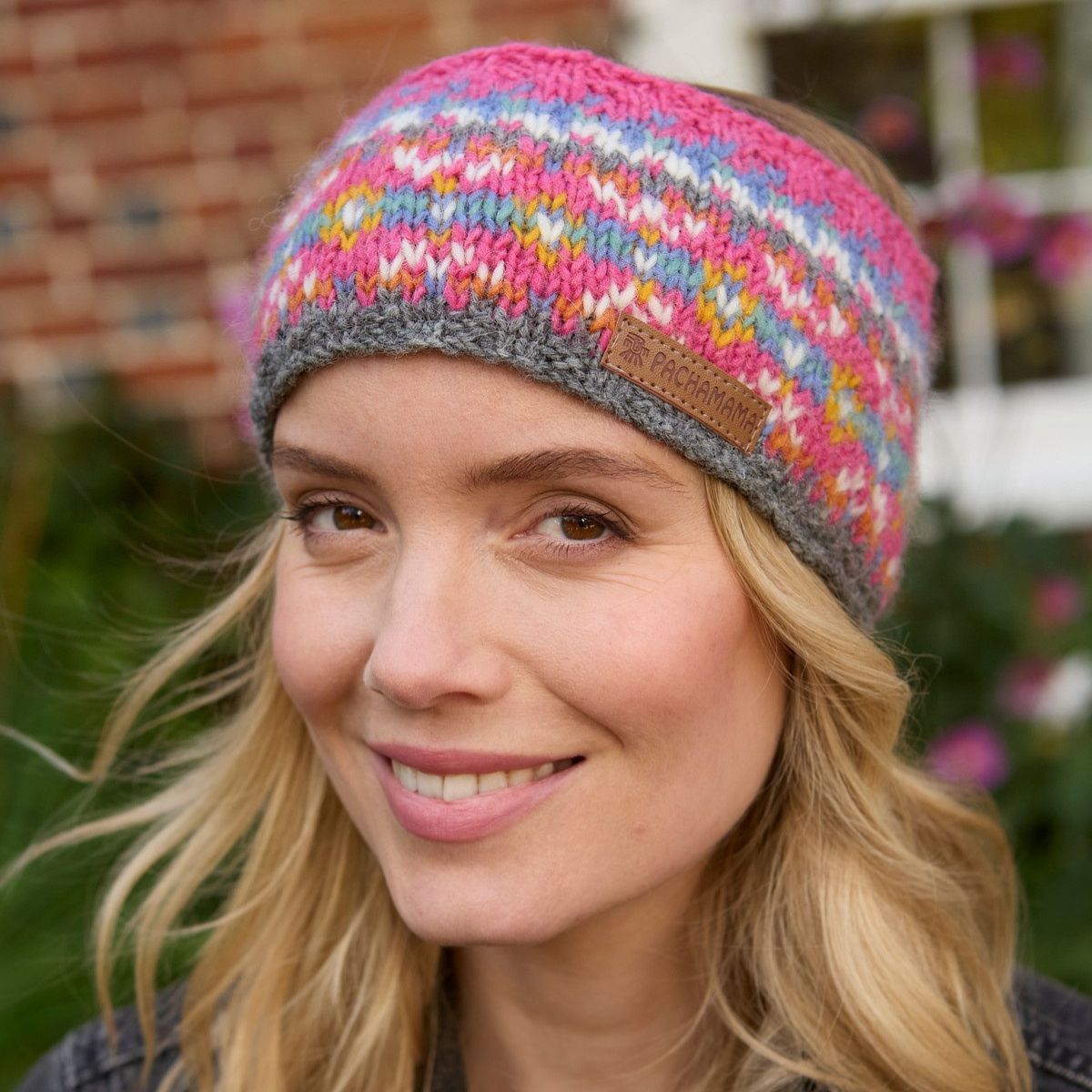 Woman wearing a colorful knitted headband with a blurred background