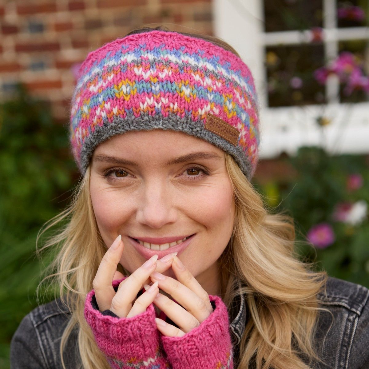 Woman wearing a colorful knit headband and gloves outdoors