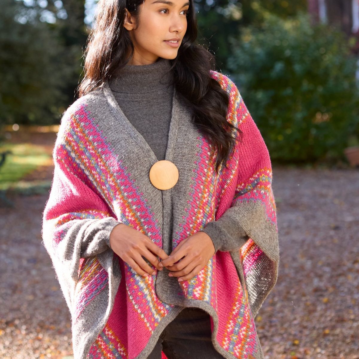 Woman wearing a colorful patterned poncho outdoors