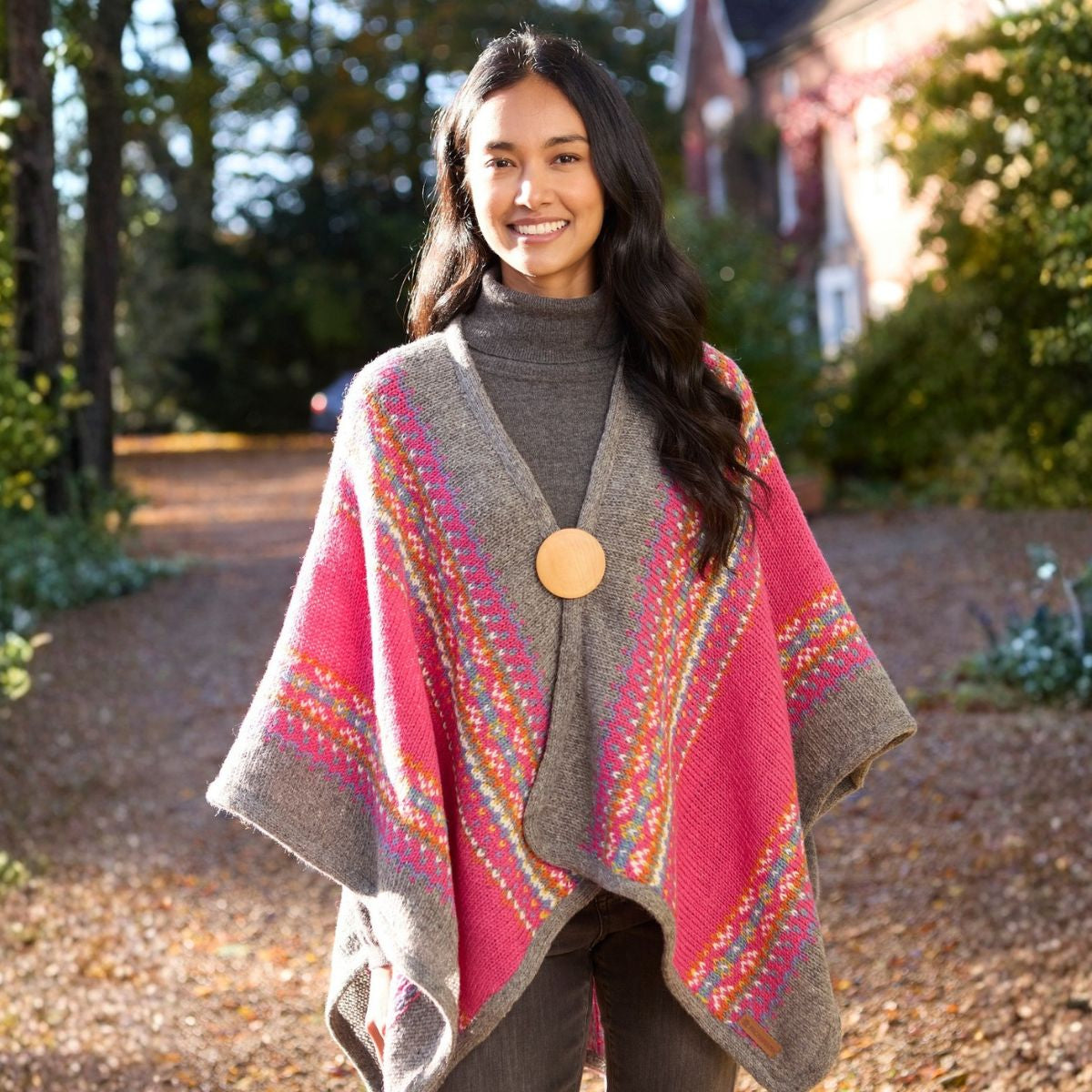Woman wearing a colorful patterned poncho outdoors