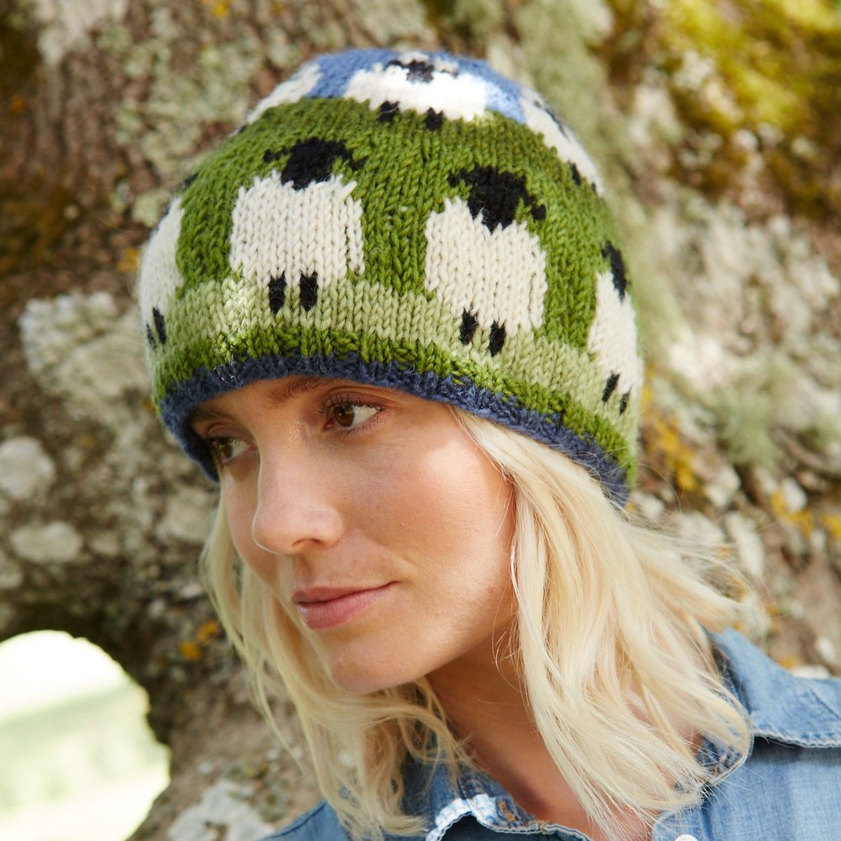 Person wearing a knitted hat with sheep pattern outdoors