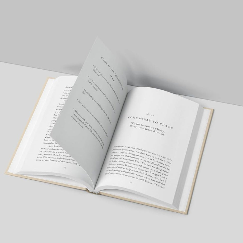 An open book with printed pages, photographed from above on a light gray surface against a gray background.