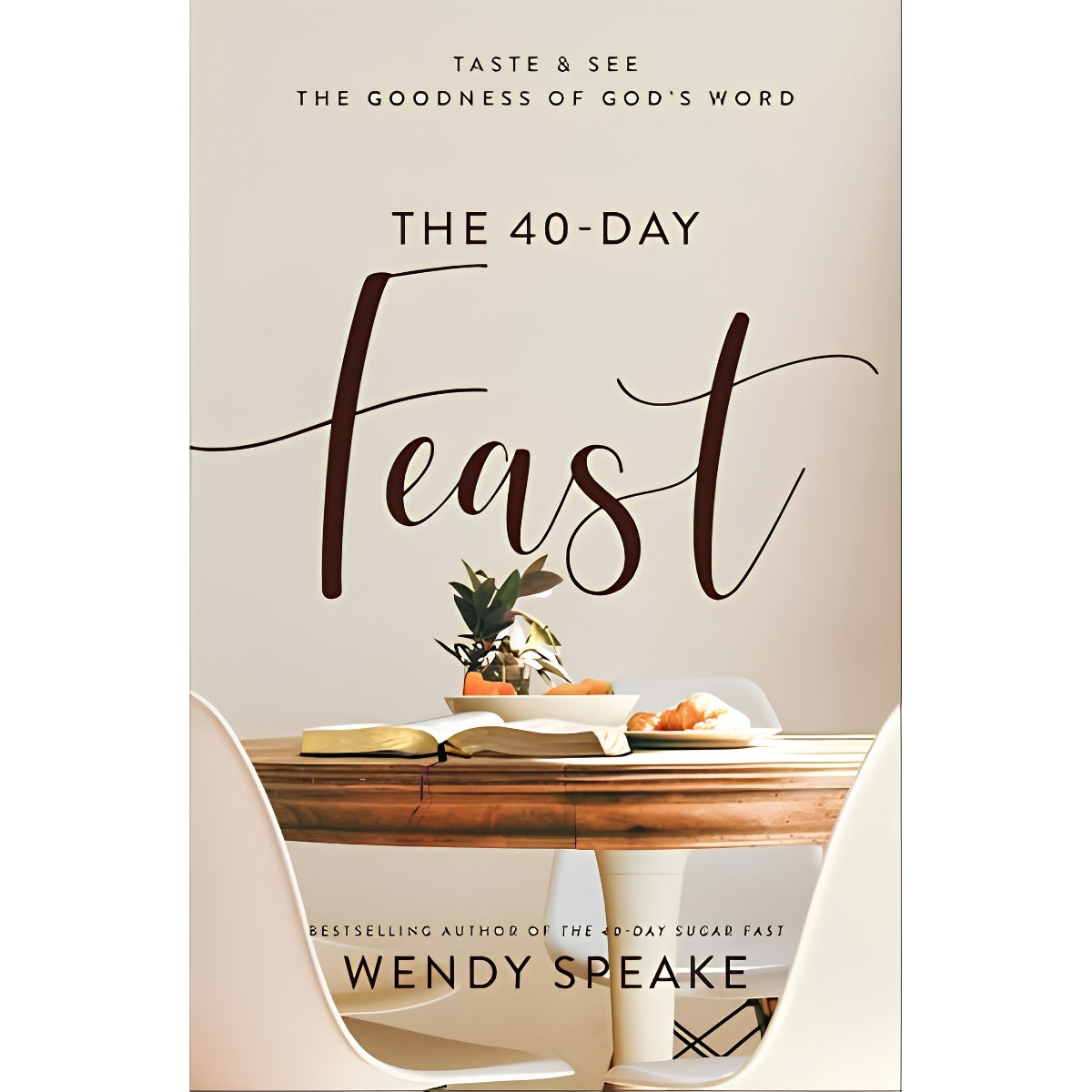Book cover for 'The 40-Day Feast' by Wendy Speake, featuring a warm beige background, elegant dark brown typography, and a styled dining table scene with a small plant and fruit.