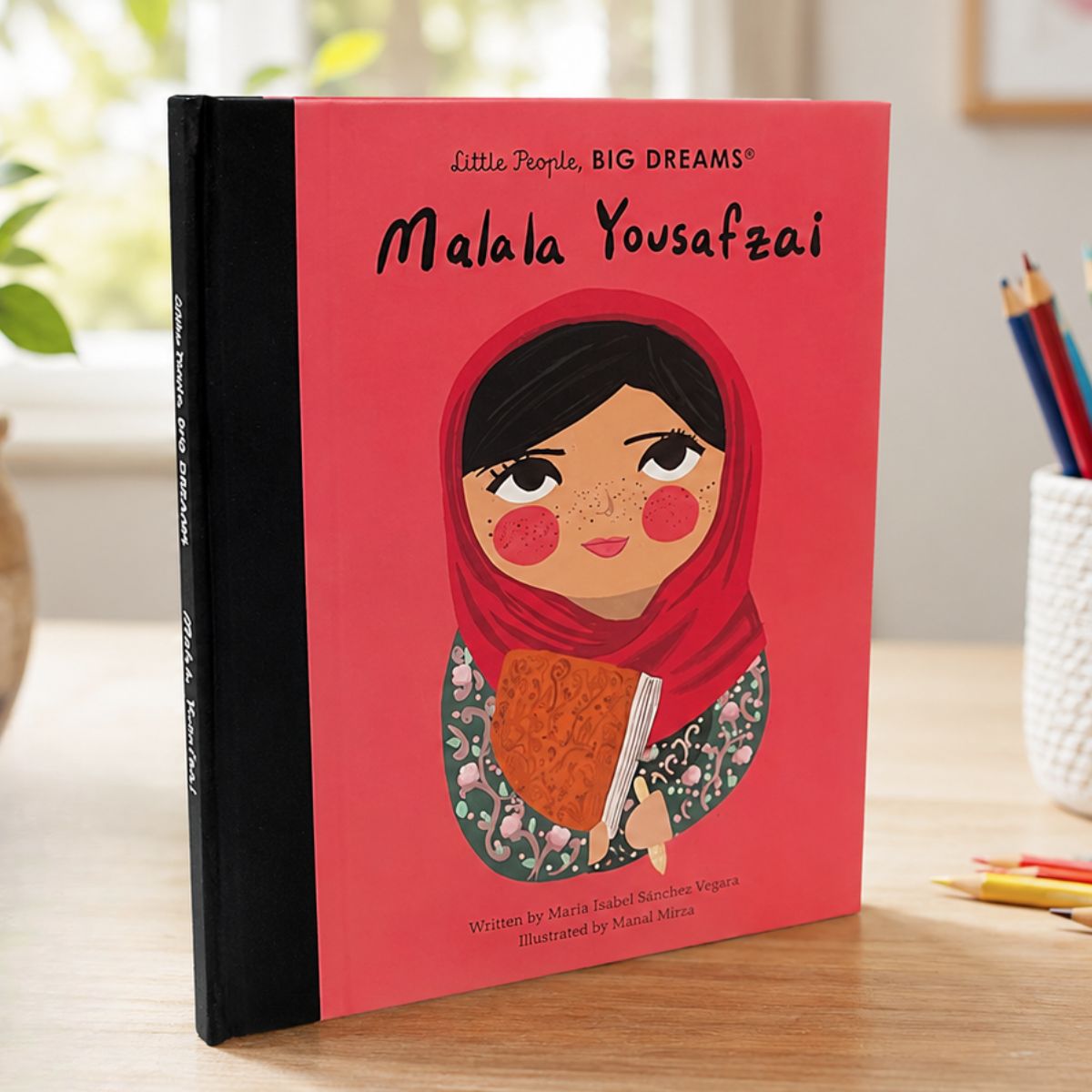 Book titled 'Malala Yousafzai' from Little People, BIG DREAMS series on a table with stationery items.