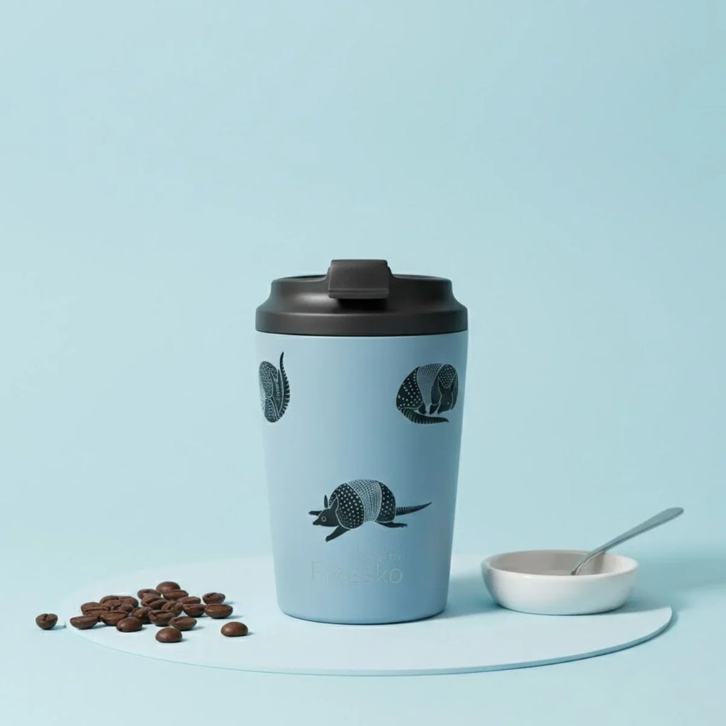 Blue travel mug with armadillo design on a light blue background