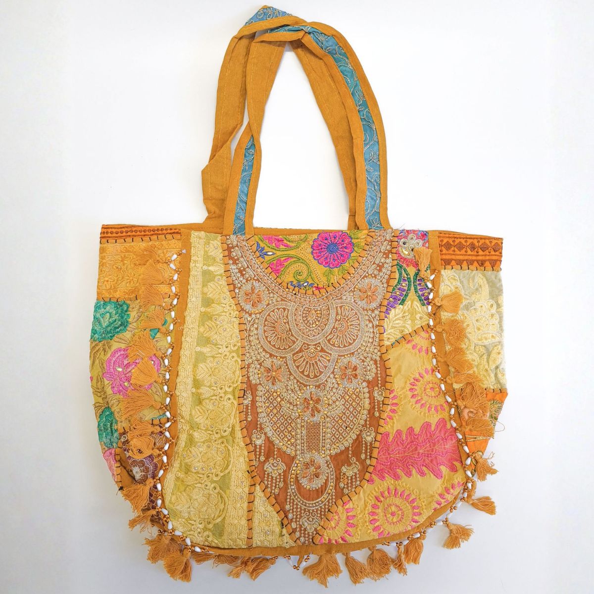 Colorful embroidered bag with tassels on a white background