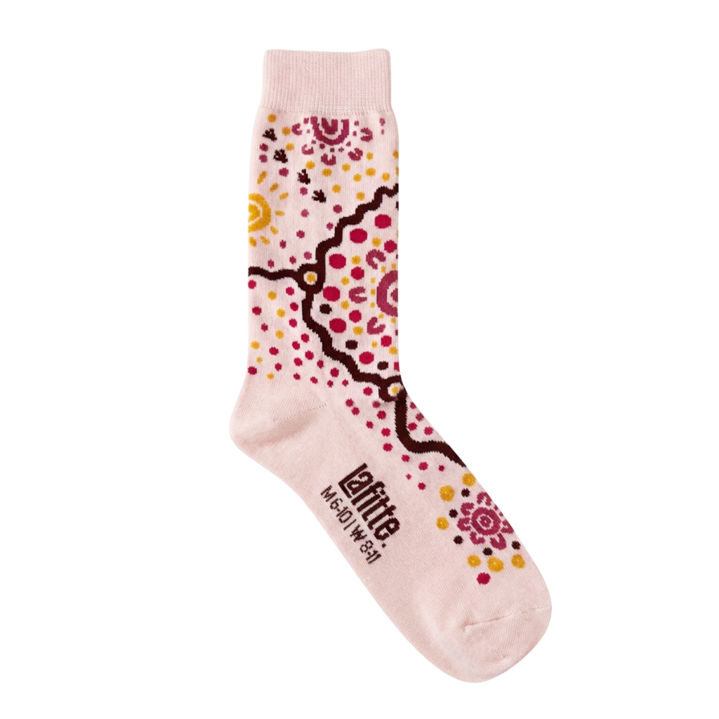 A single light pink crew sock with a colorful Aboriginal-inspired dot art pattern in red, yellow, and brown, featuring the brand name 'LaFitta' printed on the foot.