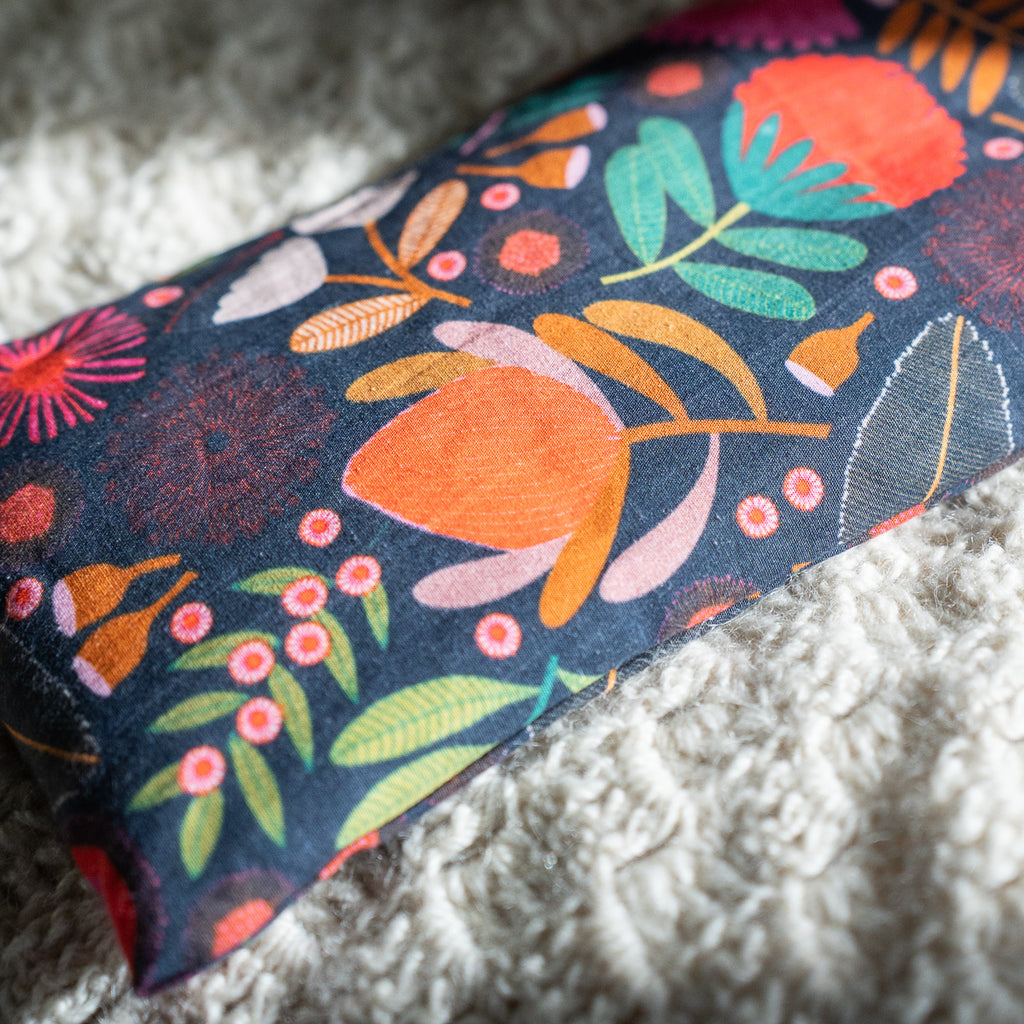 Decorative heat bag with floral pattern on a textured surface