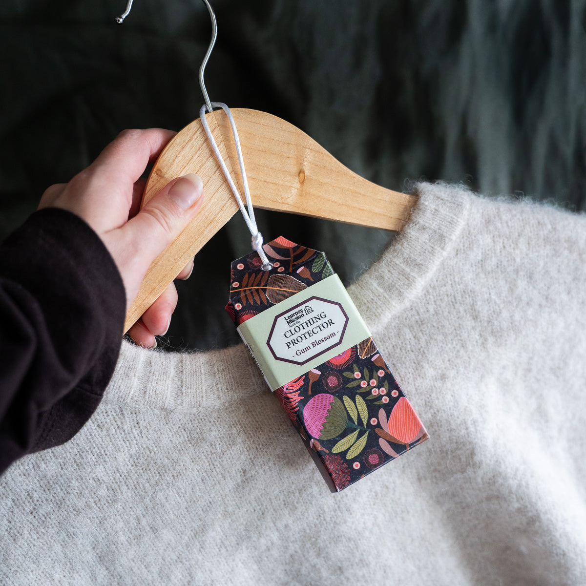 Clothing protector packaging on a hanger with a blurred background
