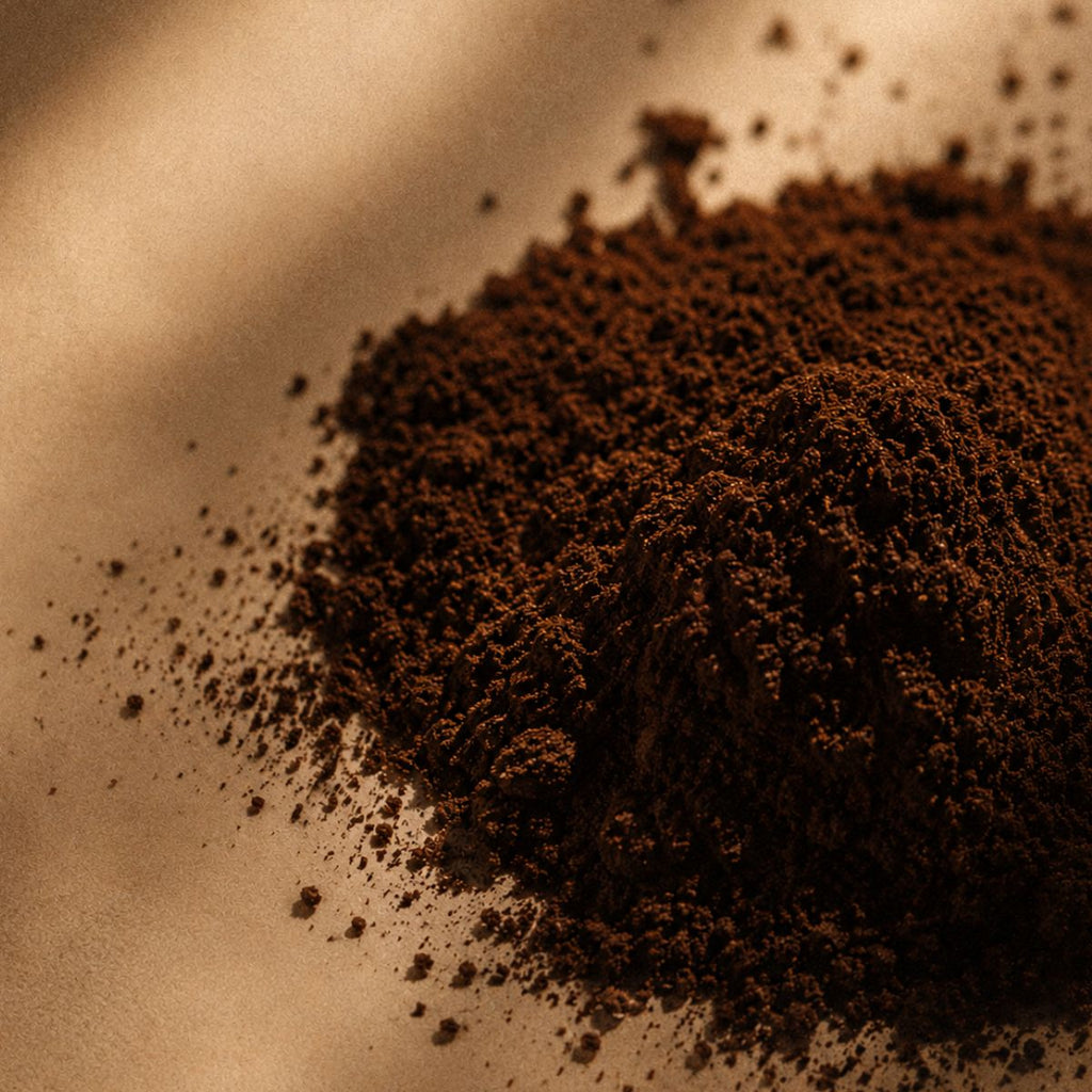 Close-up of ground coffee on a textured surface