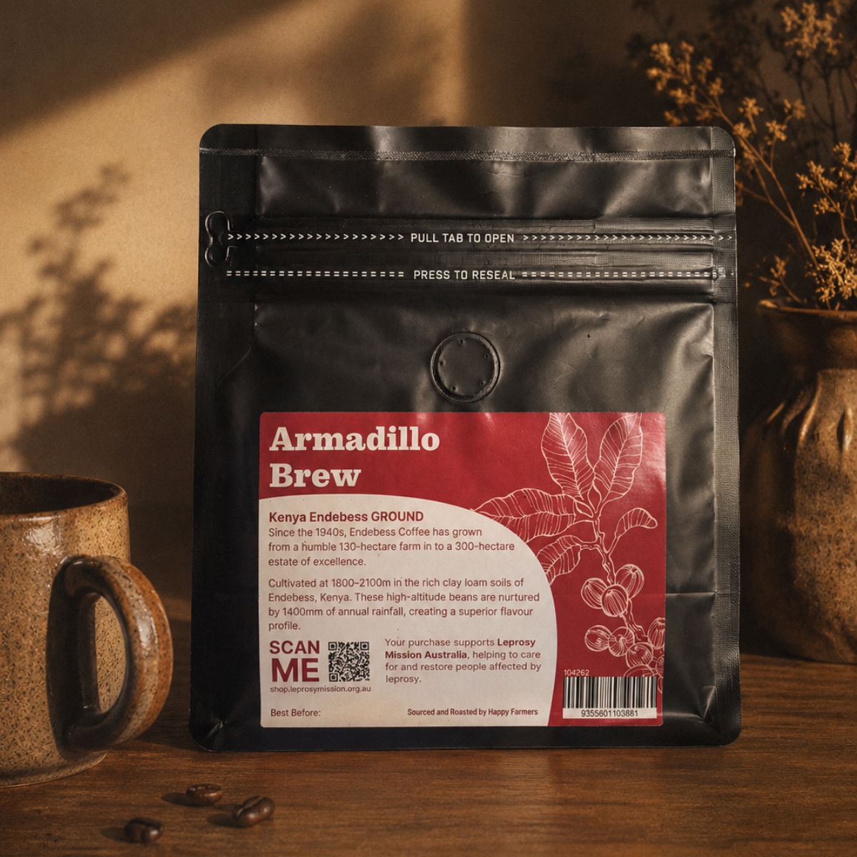 Coffee package labeled 'Armadillo Brew' with a mug and coffee beans on a wooden surface.