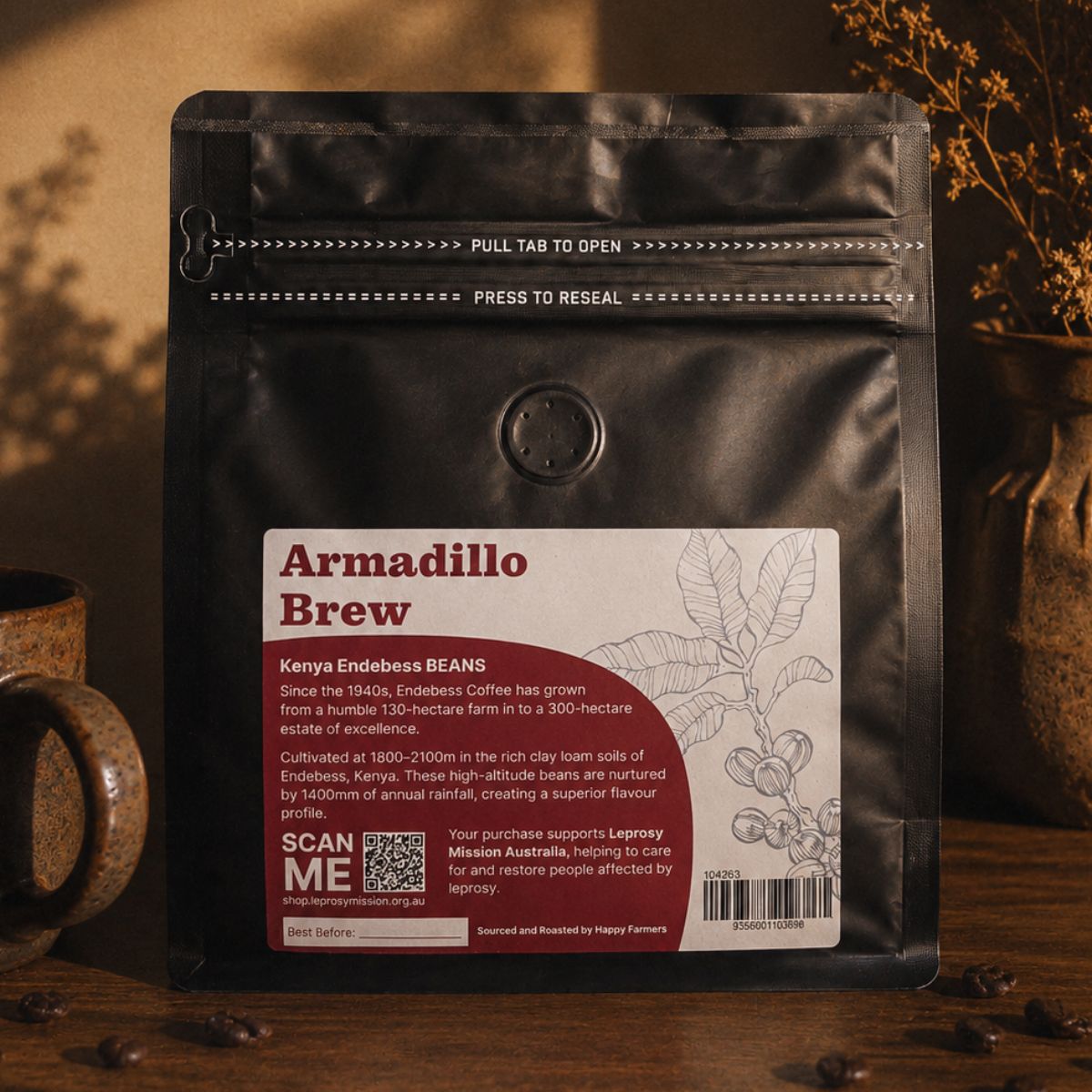 Coffee package labeled 'Armadillo Brew' on a wooden surface with a cup and coffee beans.