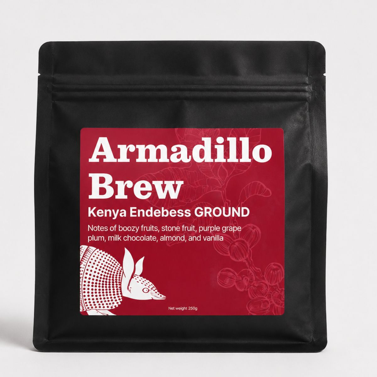 Black coffee packaging with red label featuring 'Armadillo Brew' branding on a white background