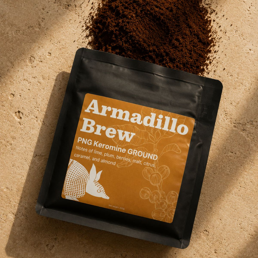 Coffee package labeled 'Armadillo Brew' with coffee grounds on a beige background