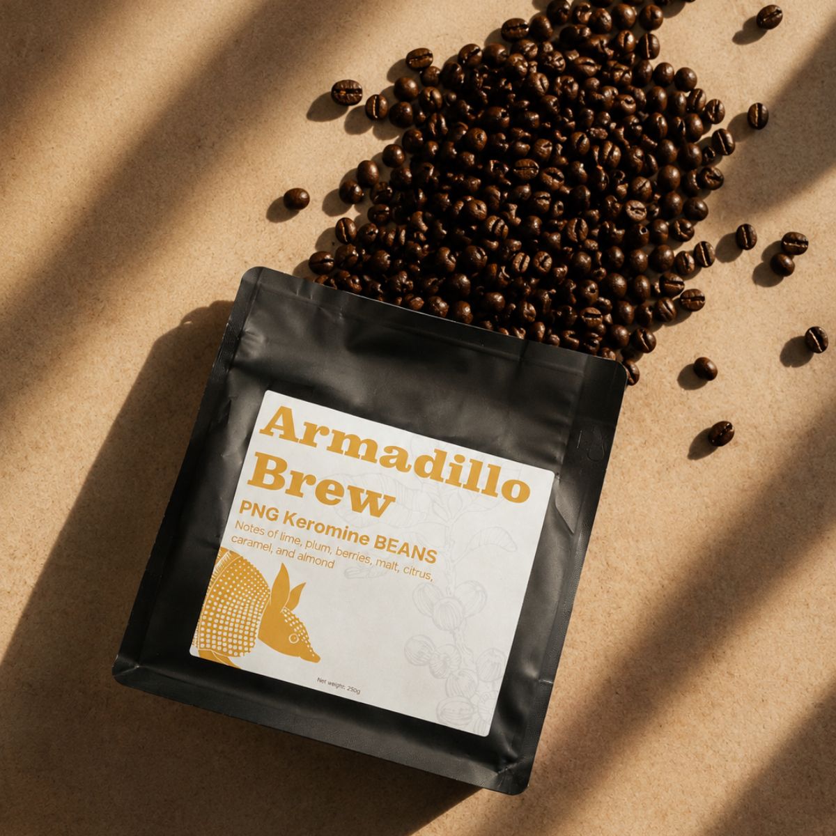 Black coffee bag labeled 'Armadillo Brew' with scattered coffee beans on a brown background