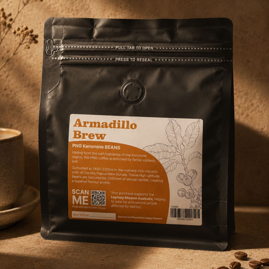 Black coffee bag with 'Ammadillo Brew' label on a wooden surface with coffee beans.