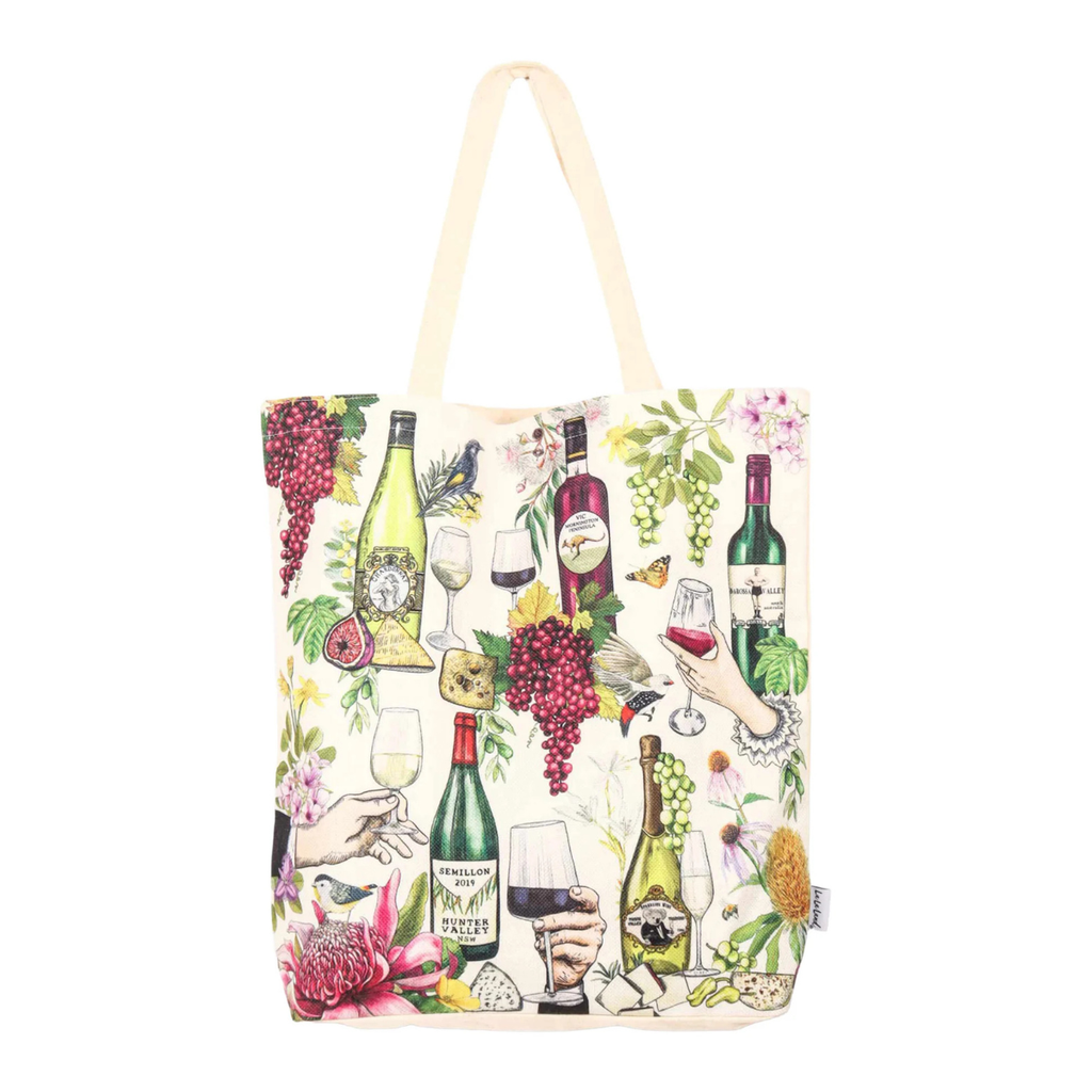 An off-white canvas tote bag featuring a colorful wine-themed illustration print with wine bottles, glasses, grapes, and hands clinking wine glasses.