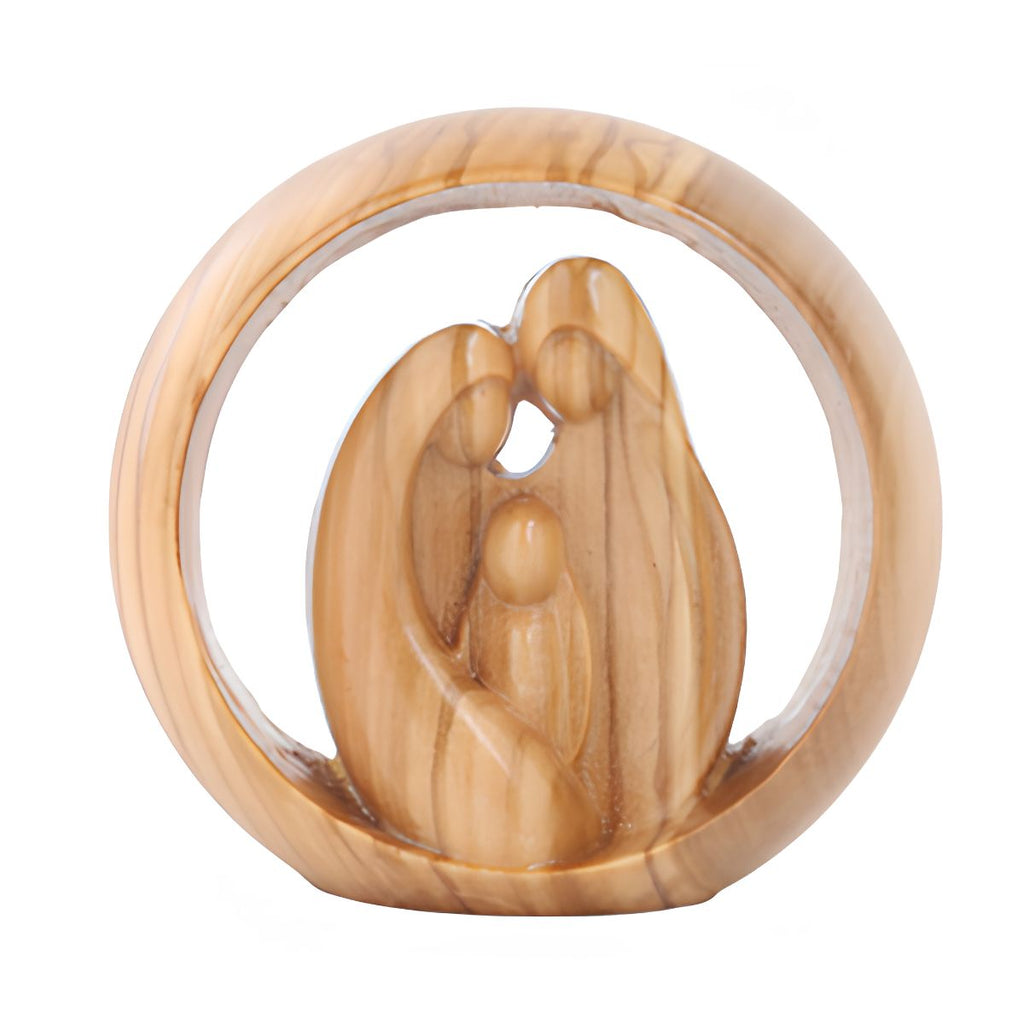 A carved olive wood sculpture of a mother and child embracing, set within a circular olive wood frame, on a plain white background.