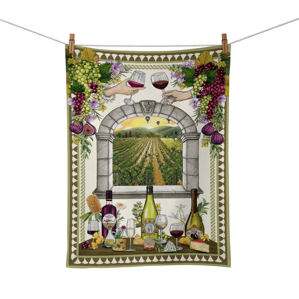 Decorative towel with wine-themed design featuring bottles, grapes, and a vineyard view.