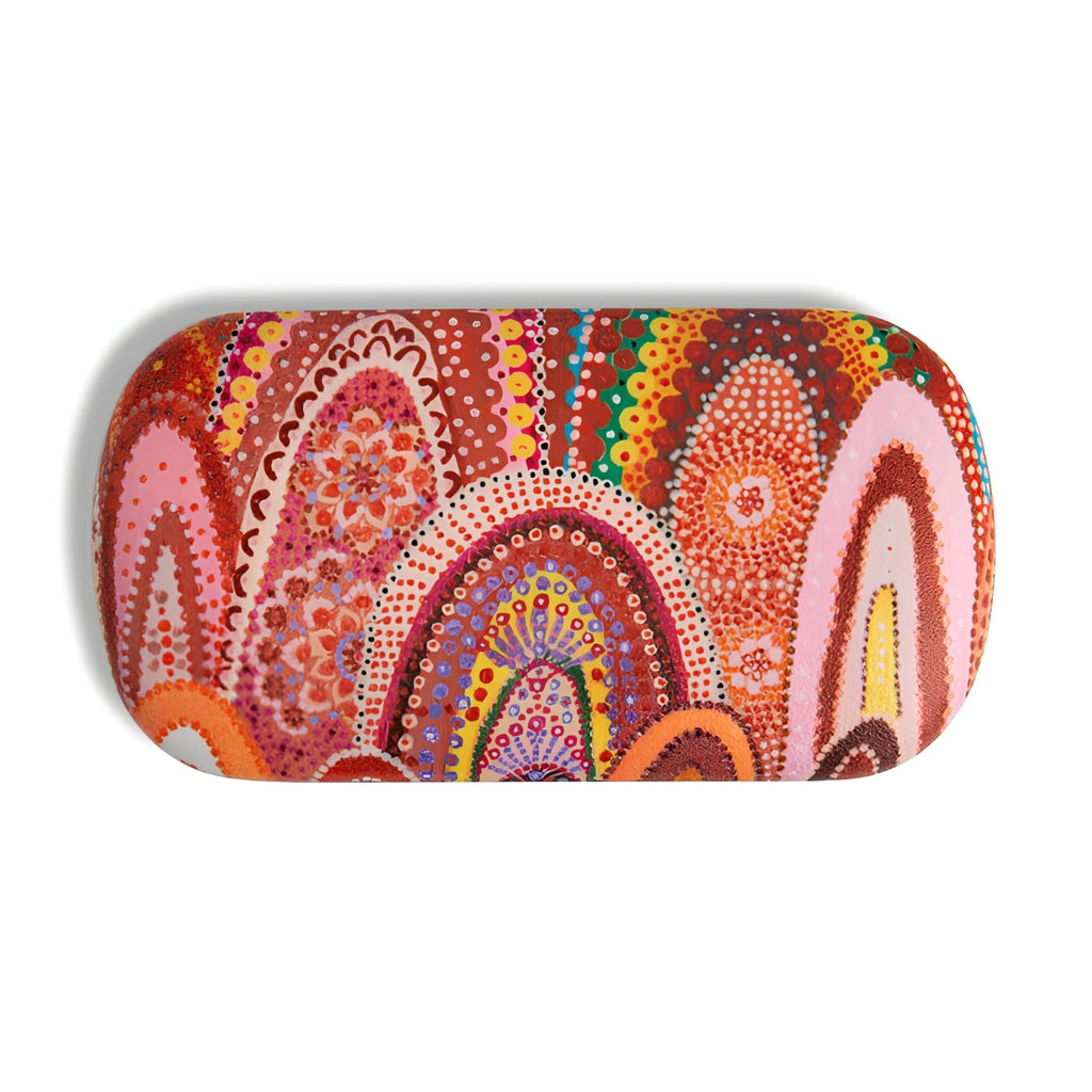 A rounded rectangular eyeglasses case featuring a vibrant, multicolored Aboriginal dot art pattern with arches and circles in red, orange, pink, yellow, and green on a white background.