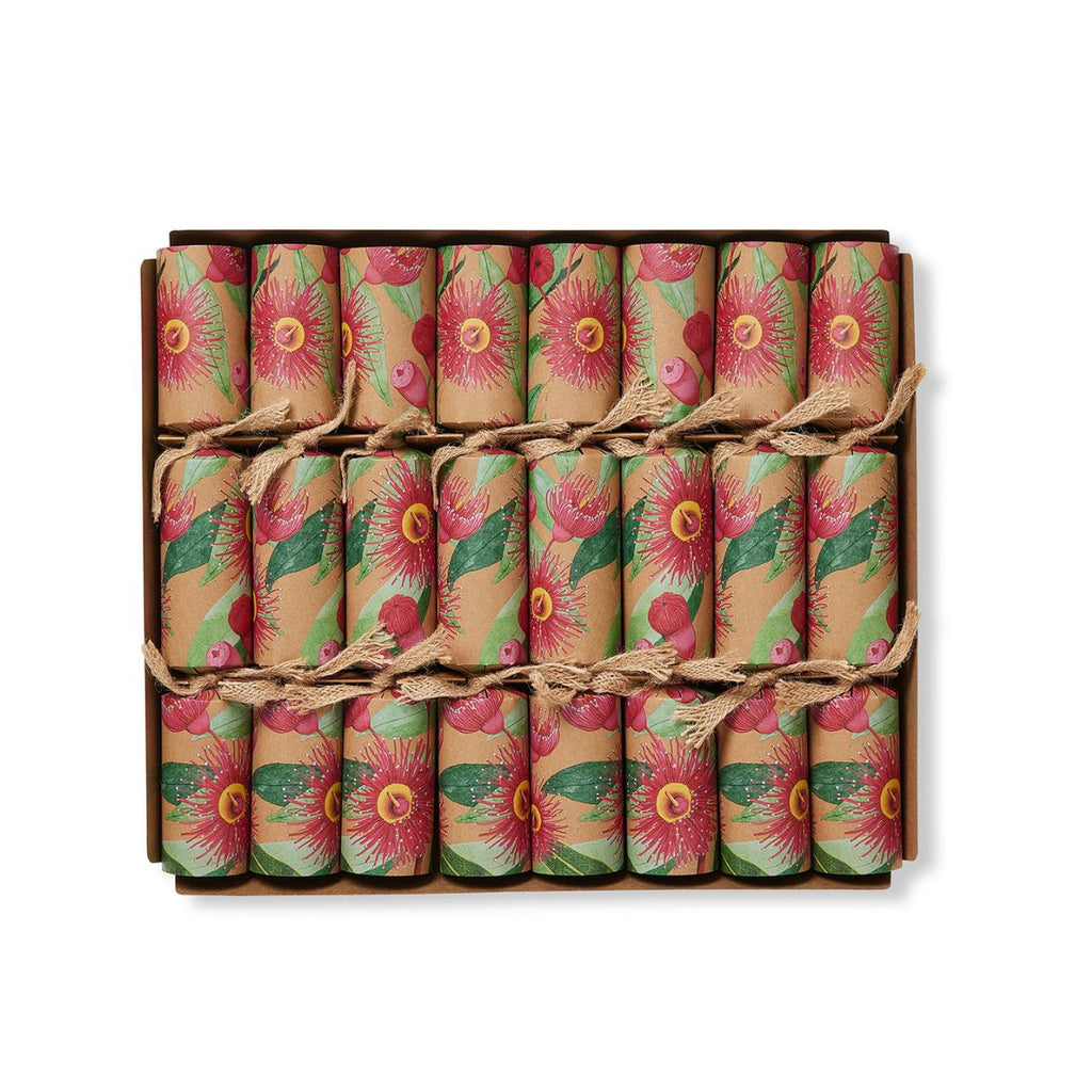 A boxed set of 18 wrapped crackers or fire crackers arranged in a 3x6 grid inside a brown cardboard box. Each wrapper has a vintage-style floral print with pink flowers, green leaves, and red berries on a tan background, tied with thin twine.