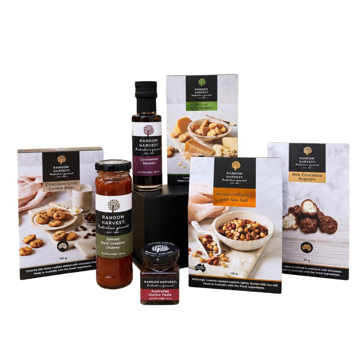 A curated food gift set from Random Harvest, featuring packaged items including a jar of chutney, a bottle of sea salt, and boxes of chocolate and nut spreads on a clean white background.