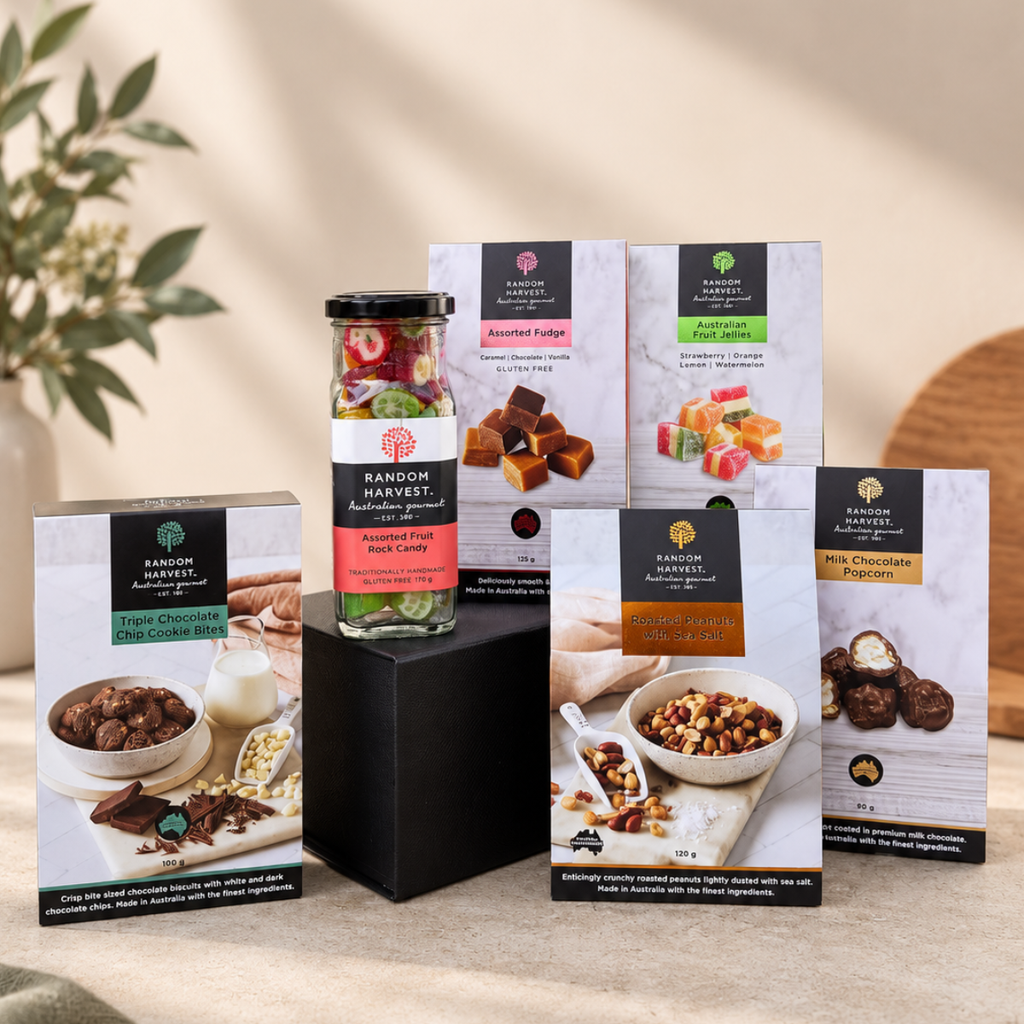 A curated assortment of Randon Harvest gourmet chocolate products displayed on a black pedestal against a warm beige background. The collection includes a glass jar of Assorted Fruits and Candy, several boxes of chocolates (Triple Chocolate, Assorted Fudge, Almond Fudge, Milk Chocolate Truffles, Dark Chocolate Truffles), and a box of Granola with chocolate.