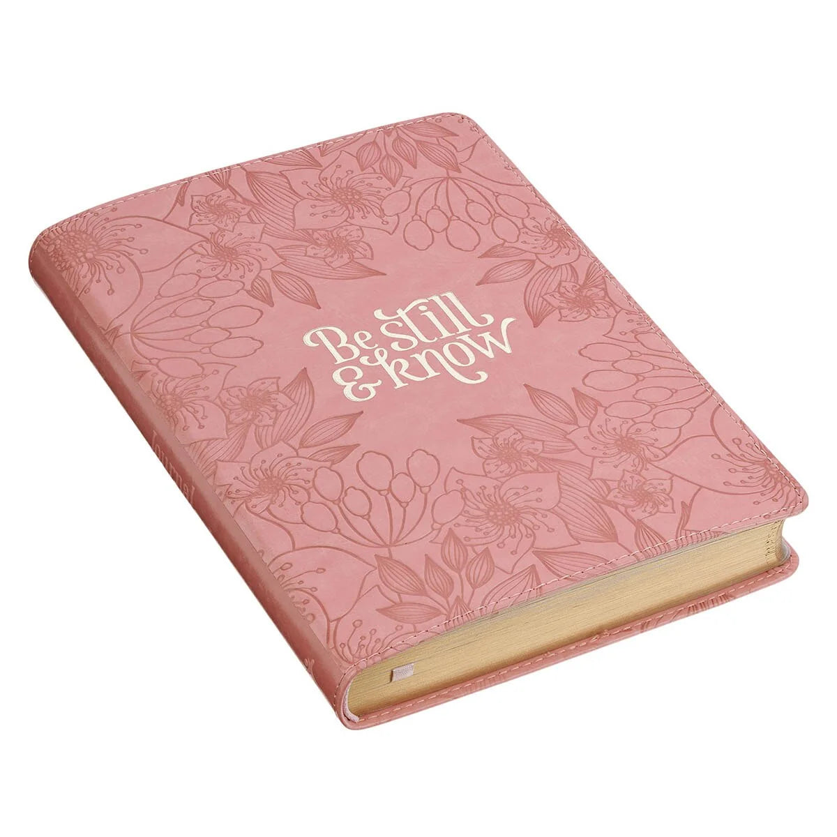 Pink notebook with floral patterns and 'Be Still & Know' text on a white background