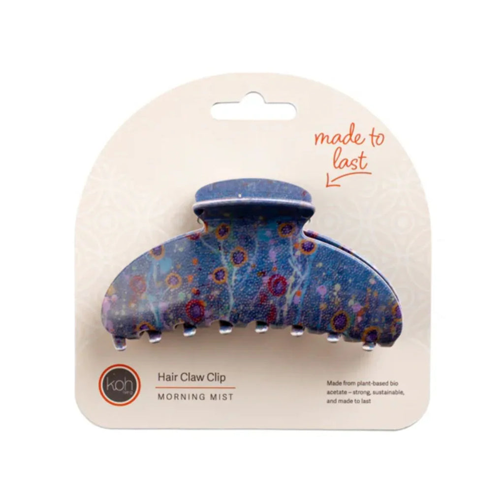 Blue floral patterned hair claw clip on a beige card with 'made to last' text