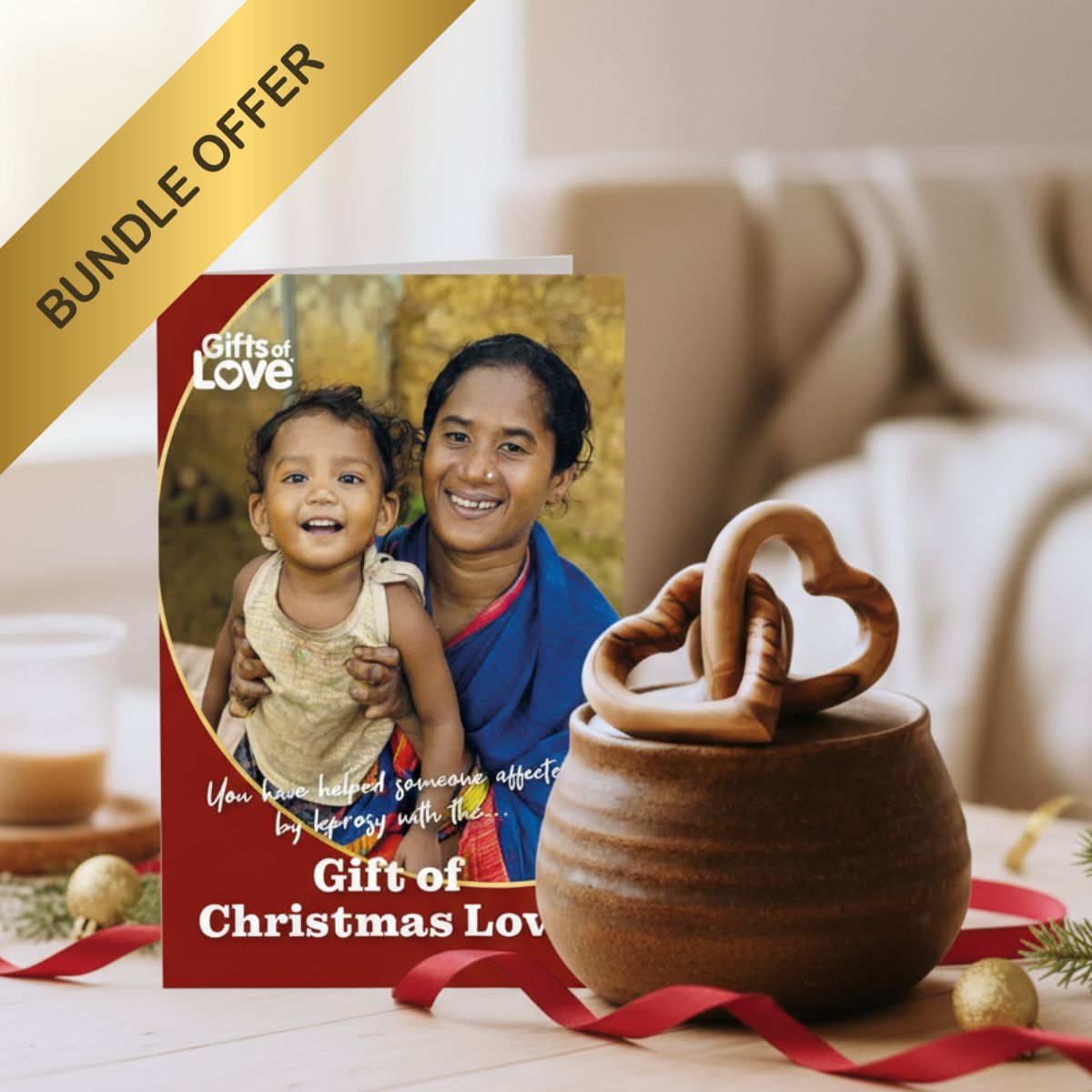 Wooden gift with heart design and 'Gifts of Love' card featuring a woman and child on a table.