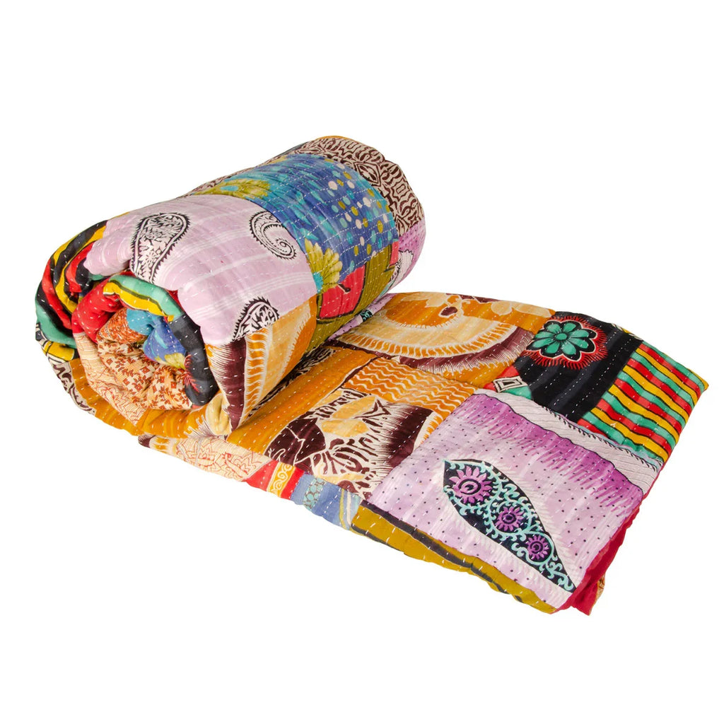 Colorful quilt with intricate patterns on a white background
